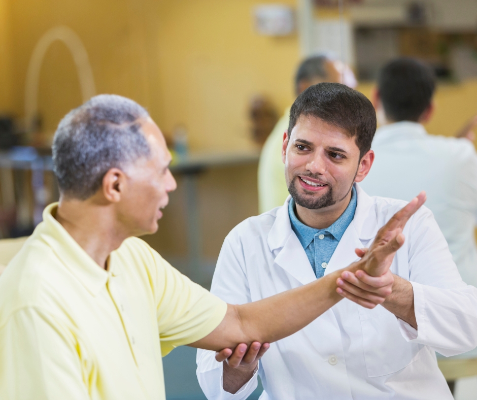 a hispanic healthcare provider checks the arm of an hispanic patient