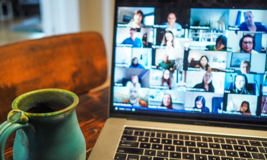 a computer showing a Zoom call with many participants