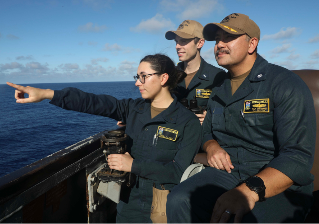 Pictured from left to right: Ensign Isabella Lanca ’22 (BA), Lieutenant Junior Grade Xavier Brenza ’21 (BA), and Commanding Officer of the USS Dewey Nicholas Hoffman ’04 (BA/BS).