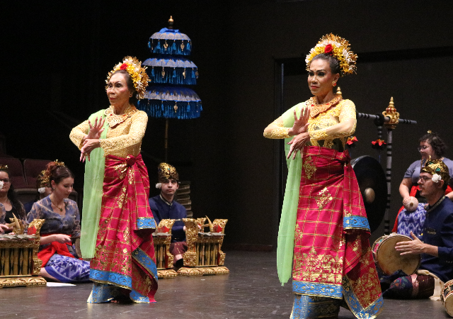 Two dancers performing with the USD Gamelan Ensemble.
