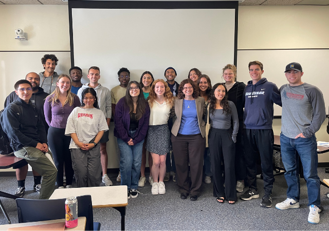 Dr. Susan Lord poses in the middle of a group of students who were a part of her solar energy course.