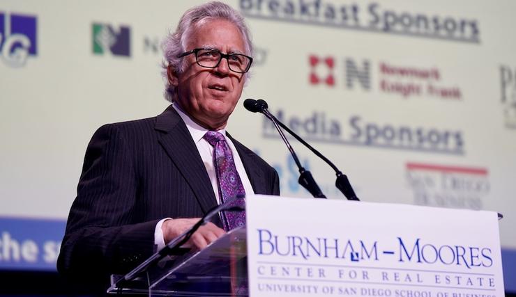 Stath Karras, executive director of the Burnham-Moores Center for Real Estate at the podium at the 23rd Annual Real Estate Conference