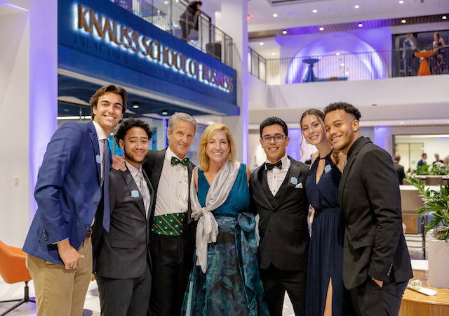 image of Don and Ellie Knauss with USD students inside the Knauss School of Business