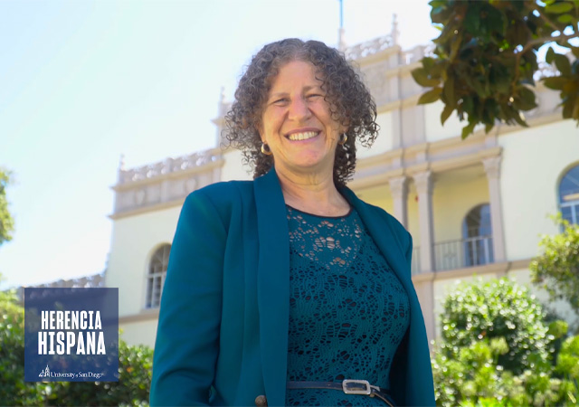 Image of Perla Myers, PhD, in front of Saints Tekakwitha & Serra Ha