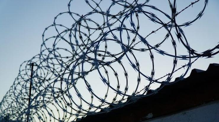 barbed wire on top of border wall