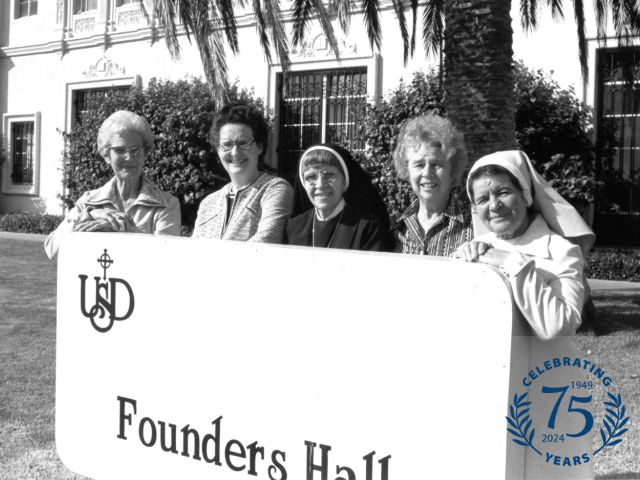 1989 - founding sisters standing next to Founders Hall sign at USD
