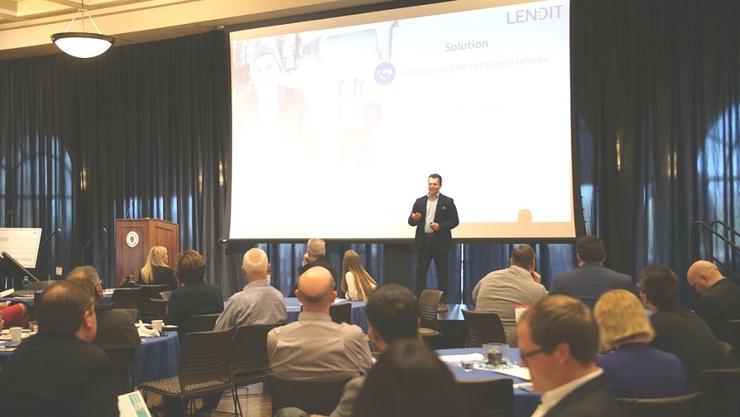An entrepreneur stands on a stage to pitch his idea at the San Diego Angel Conference