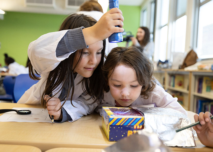 STEM Outreach Club member works with Linda Vista Elementary student. 