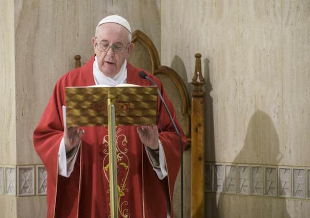 Pope Francis reading from scripture at podium