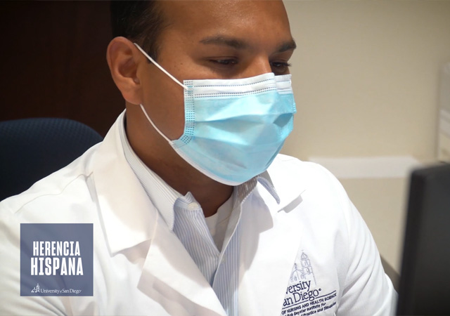 Image of Pedro Alonso Colio in his white coat working at a computer