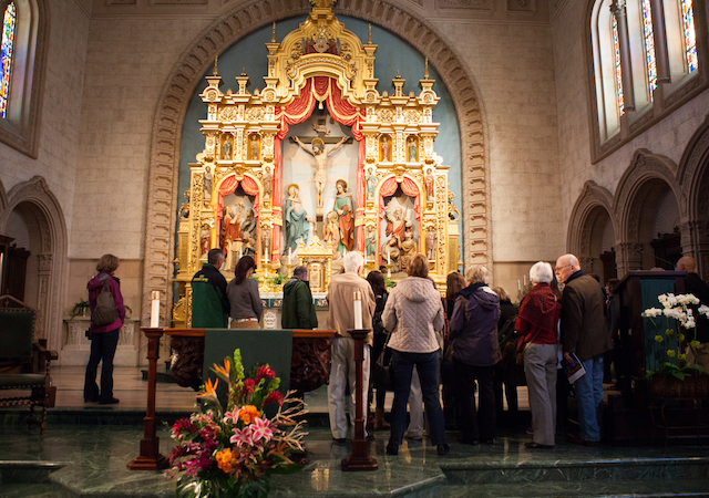 Tour group gathered around the altar in Founders Chapel