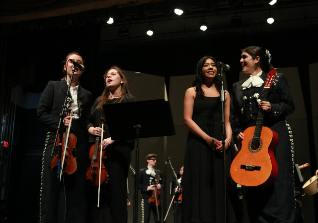 USD Mariachi ensemble performing on stage.