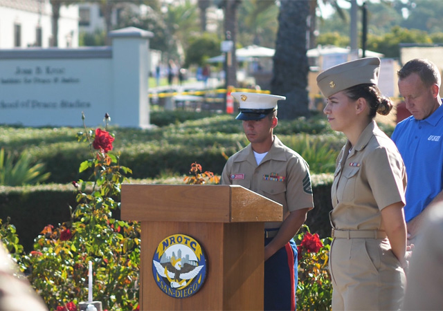 Image from 9/11 remembrance event featuring members from the NROTC color guard in the memorial garden