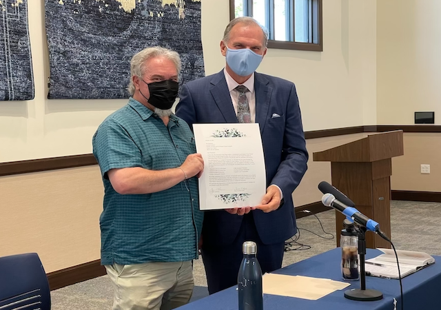 President Harris and Professor Boudrias holding Laudato Si' document