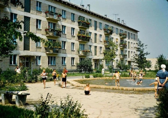 image of an apartment complex with children playing outside