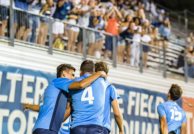 Men's soccer celebration of a goal