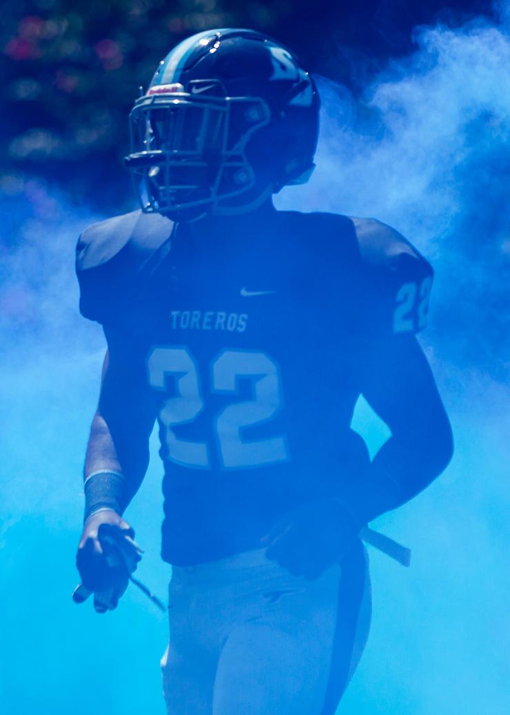 Daniel Tolbert runs through blue smoke