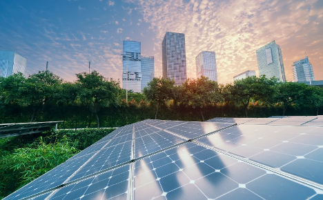 Solar panels with a city skyline in the background