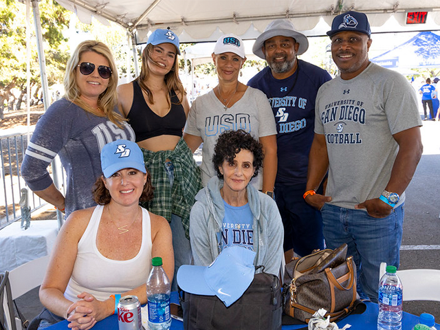 7 alumni posing for a group photo at 2021 tailgate event