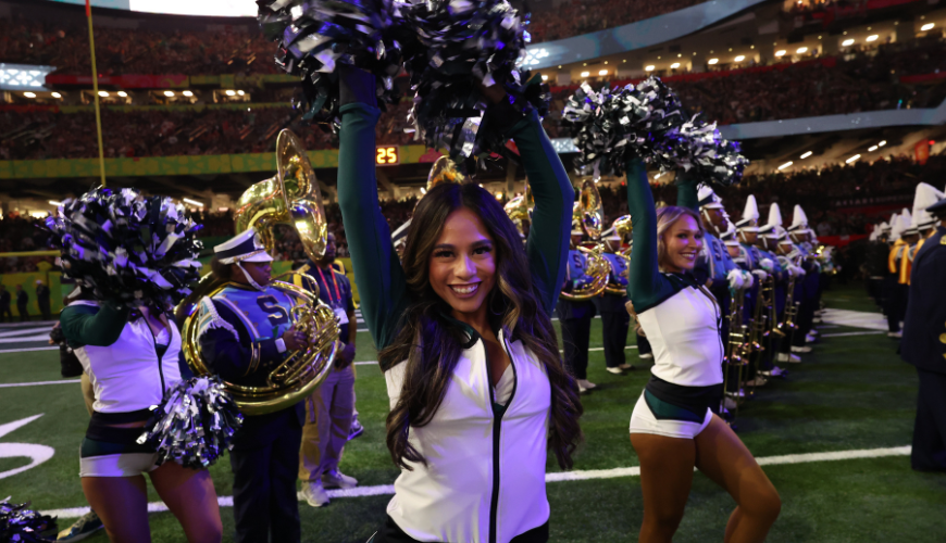 Hanna Sahagon poses in her Philadelphia Eagles cheerleading outfit holding poms.
