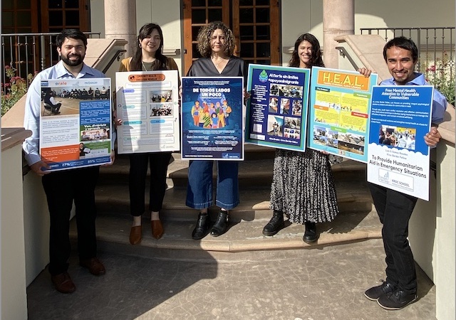 Border Fellows holding posters representing their initiatives