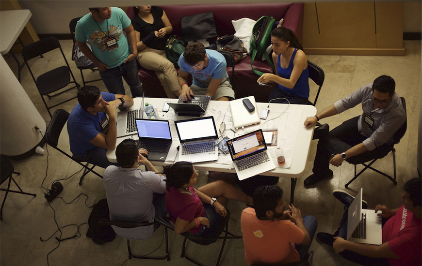 Entrepreneurs working together at a shared table and computers