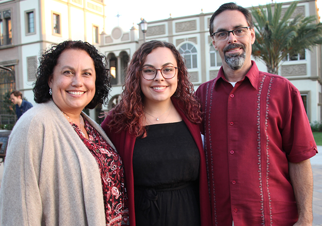 Sage McNeeley, middle, celebrates her academic achievement with family after attending the Mid-Year Graduates Mass in Founders Chapel on Dec. 13, 2019.