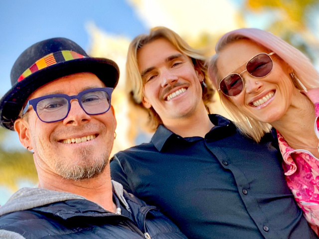 Picture of the Wahl family, including Erik Wahl on the left, son Harley Wahl in the middle, and Tasha Wahl on the right, all standing in front of the Immaculata.