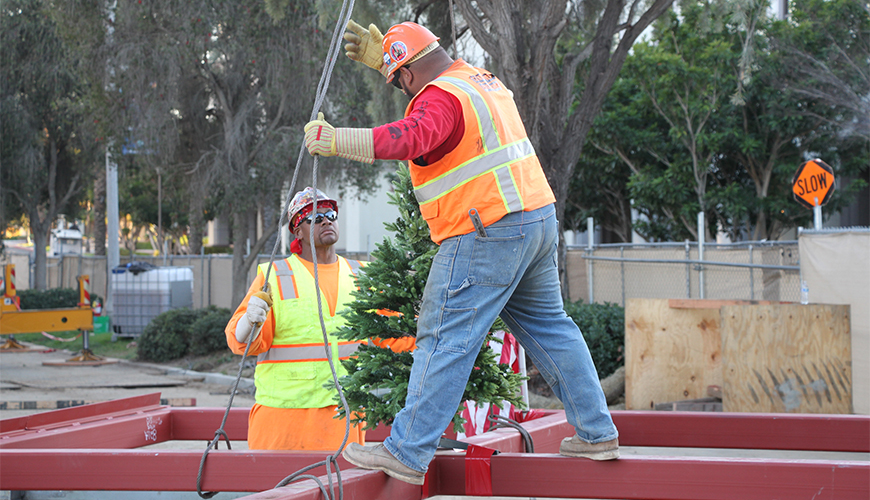 Construction of the Learning Commons, seen here during a Topping Off Ceremony in December 2019, is continuing during the current COVID-19 pandemic.