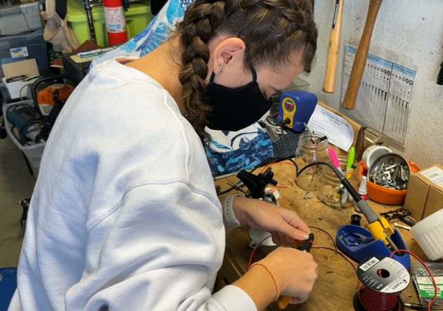 Glaukos team member works on team's prototype