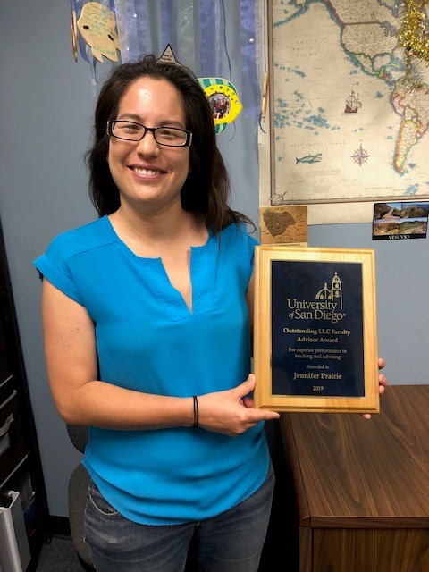 Dr. Prairie holds up her award.