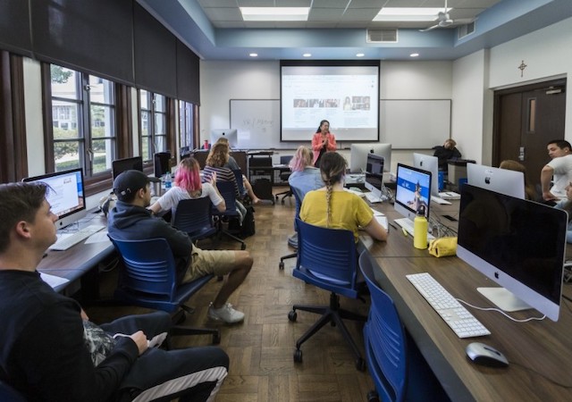 students in class with teacher at podium
