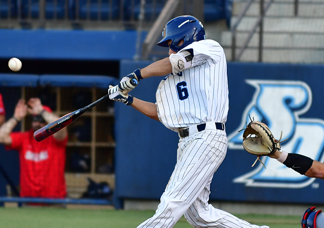 Paul Kunst swings bat at ball