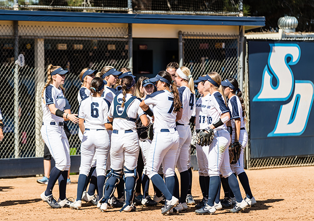 USD softball player huddle