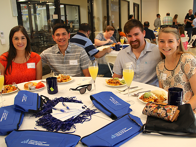 4 engineering alumni posing at 2022 engineering brunch