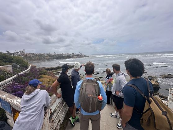 Dr. Jerome Hall points out the formation known as Bird Rock–a key location in San Diego surf history and culture.