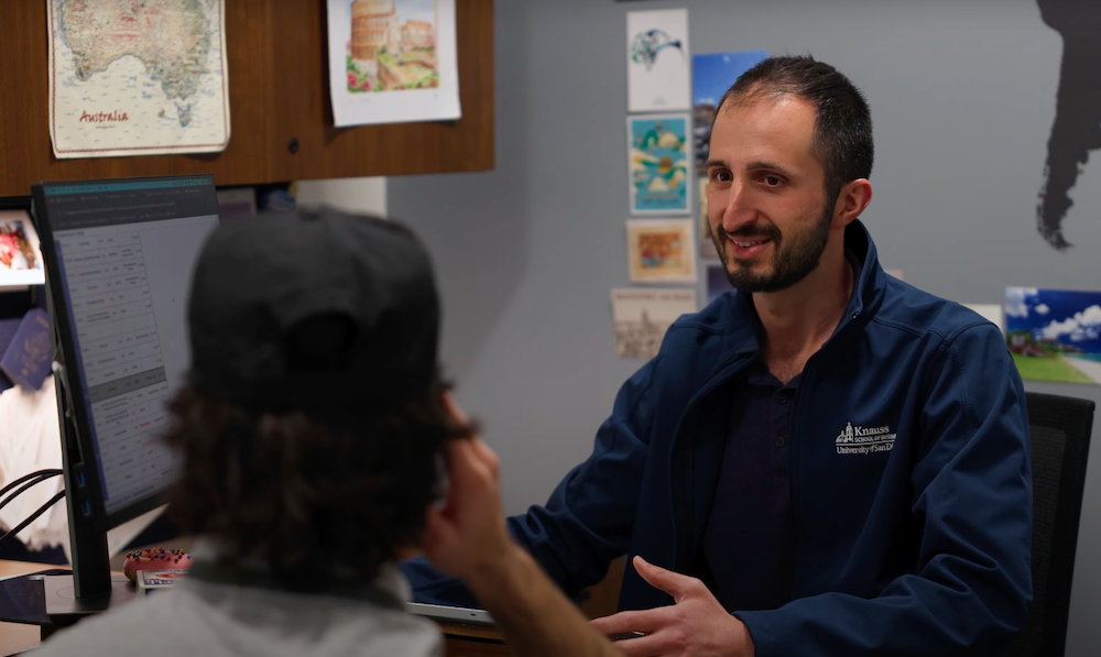 Michael Castronuovo Jr sitting with and advising a student 