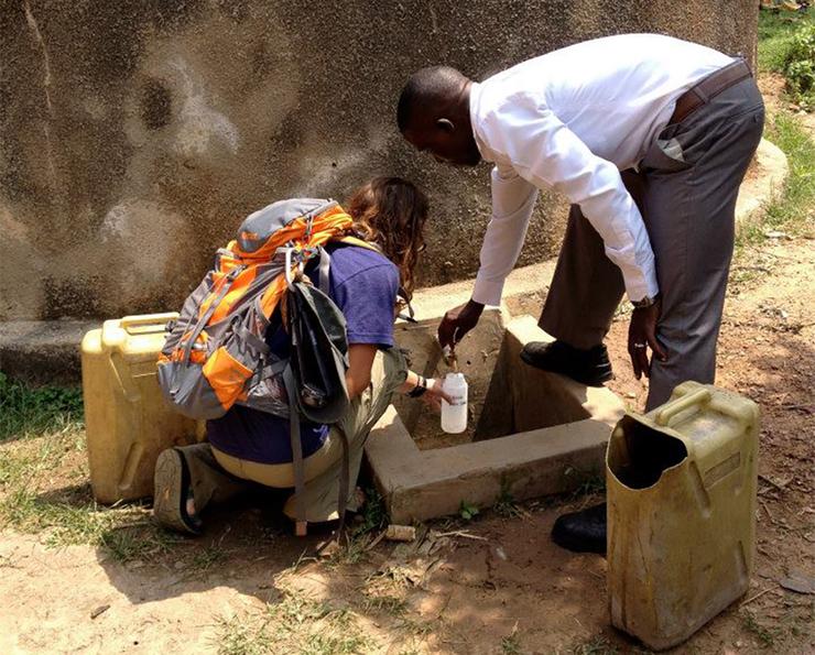 Students on a past trip to Uganda work on water samples in a makeshift lab.