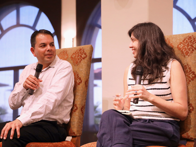 Rios interviews a woman at the Kroc Theatre at USD