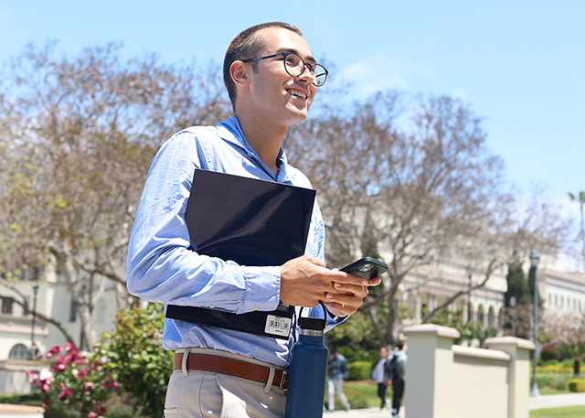 USD President for a Day Robert Justice walks into the Hughes Administration Building.