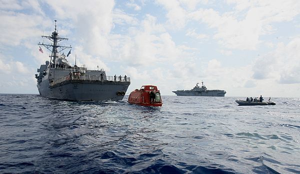 MV Maersk Alabama lifeboat behind a US Navy destroyer and amphibious assault ship.
