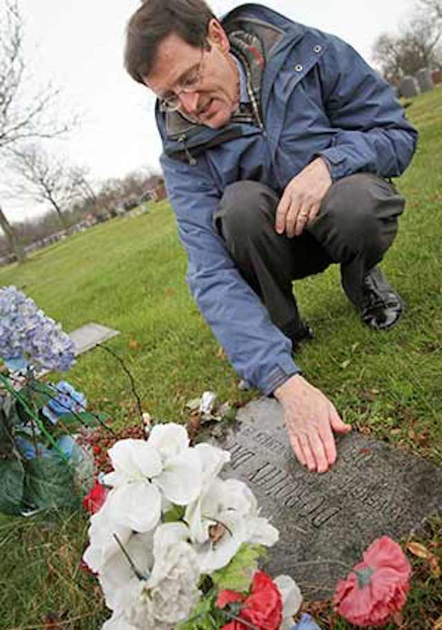 patrick jordan kneeling by Dorothy Day's gravesite