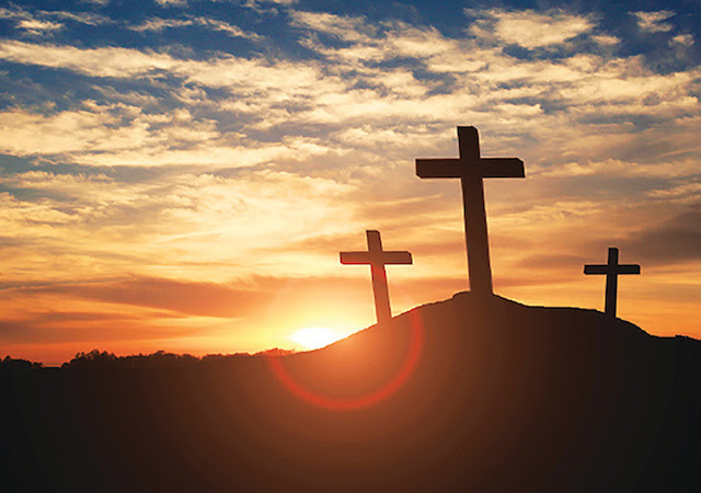 Image of a sunrise and crosses on a hill