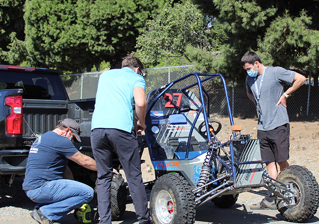 Engineering students working on the baja buggy