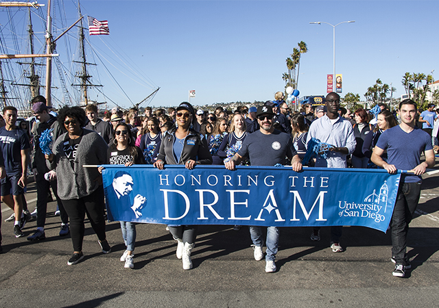 MLK Parade photo from 2019 parade with USD's MLK banner