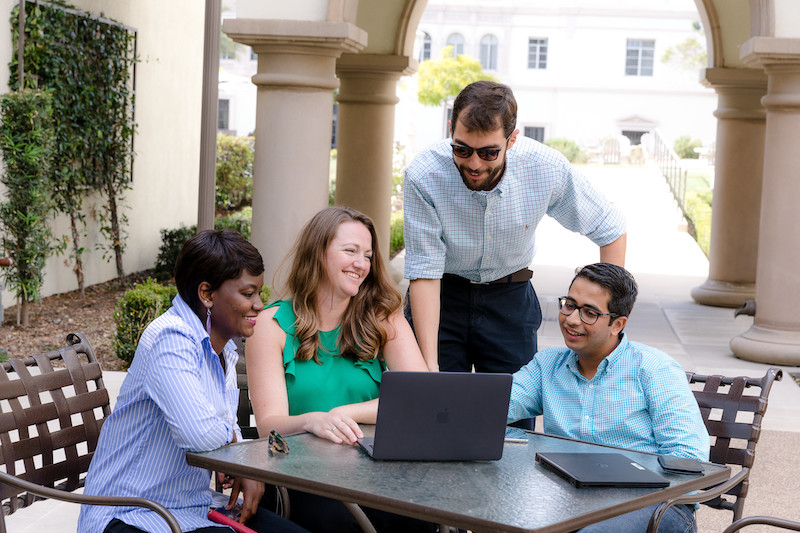 MBA students working at a table on the University of San Diego campus