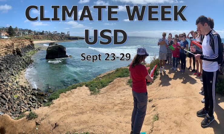 A group of students stand by the ocean and take notes as their professor gives a lecture.