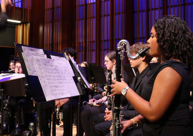USD Wind Ensemble performing on stage.