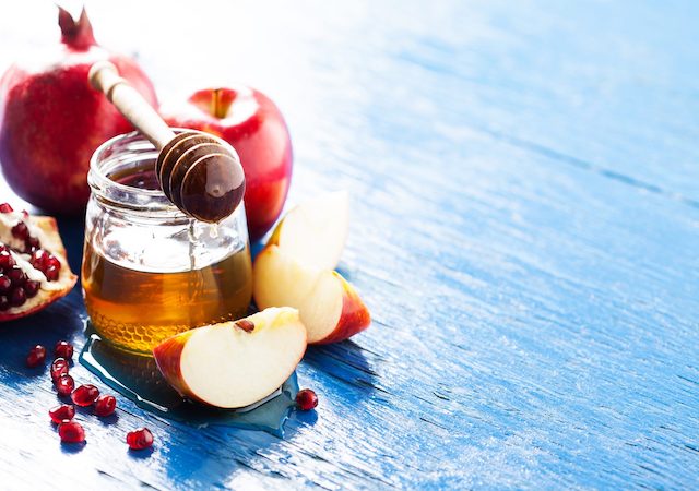 Apples on a table dipped in honey