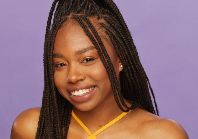 Shiley-Marcos School of Engineering student Aliyah Jones smiles wearing an orange tank top in front of a purple background.